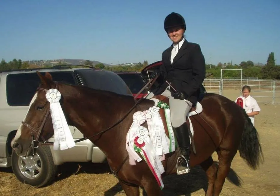 Horse and rider wearing show ribbons